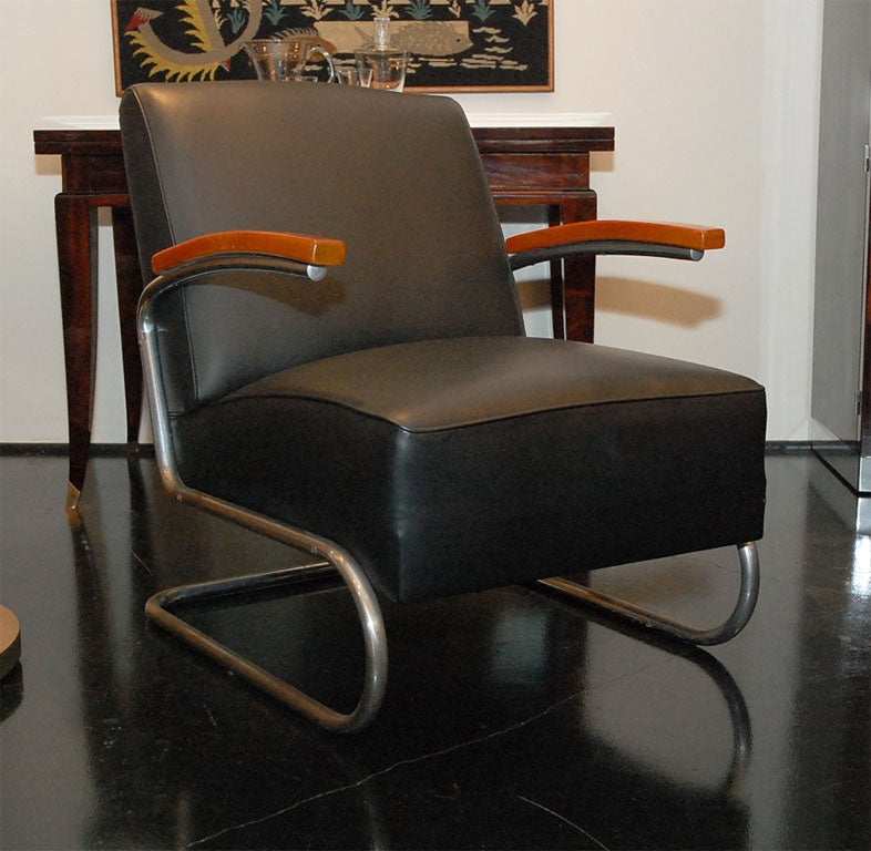Pair of Thonet Lounge Chairs. Model S411. Signed Thonet on back of arm. Wooden arms with chrome cantilever frame. Upholstered in black leather.