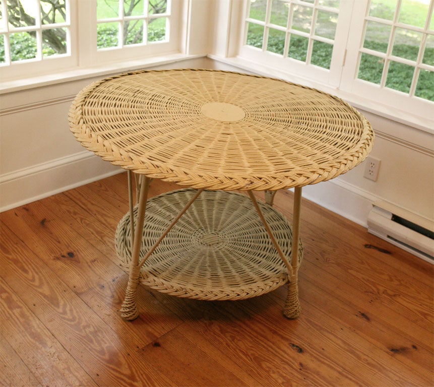 Traditional style round Bar Harbor wicker table in tan paint.  Woven top and bottom shelf with braided border.  Pineapple-twist feet.
