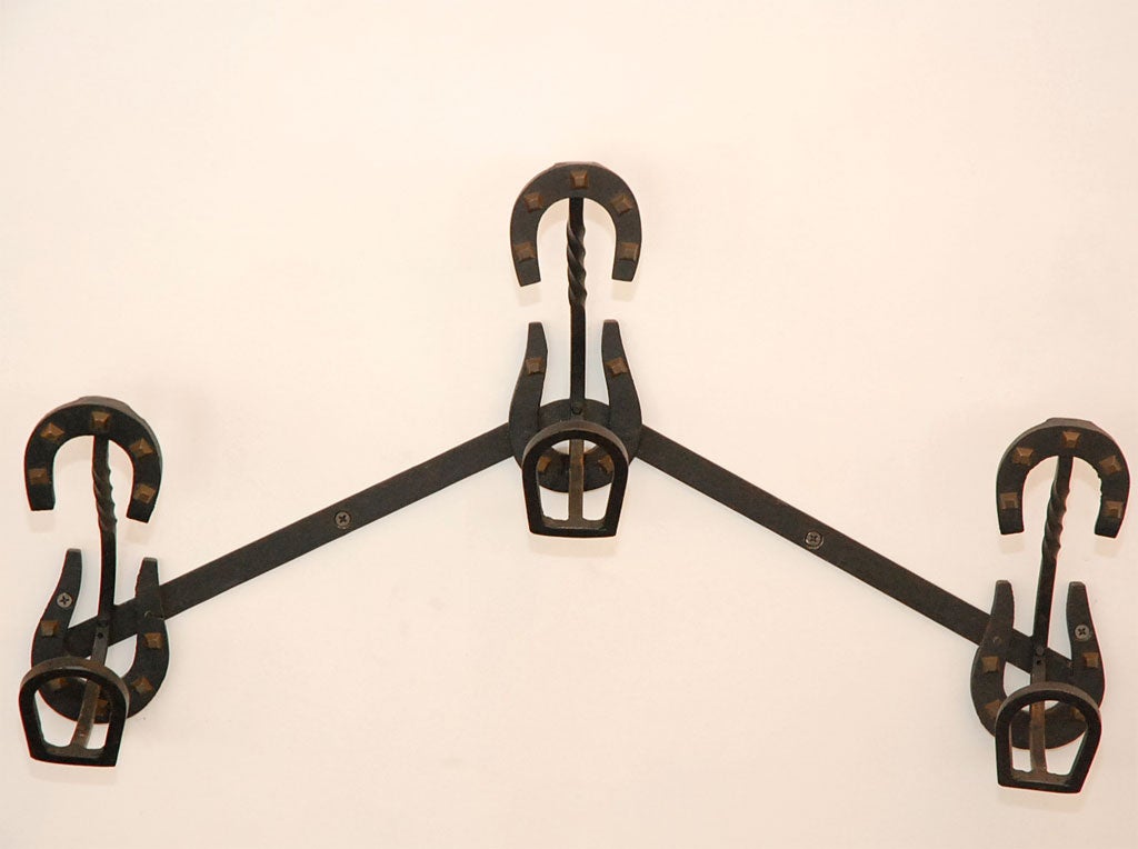 Unique horseshoe iron coatrack attributed to Jacques Adnet.  Great sculptural piece with brass stud detail.