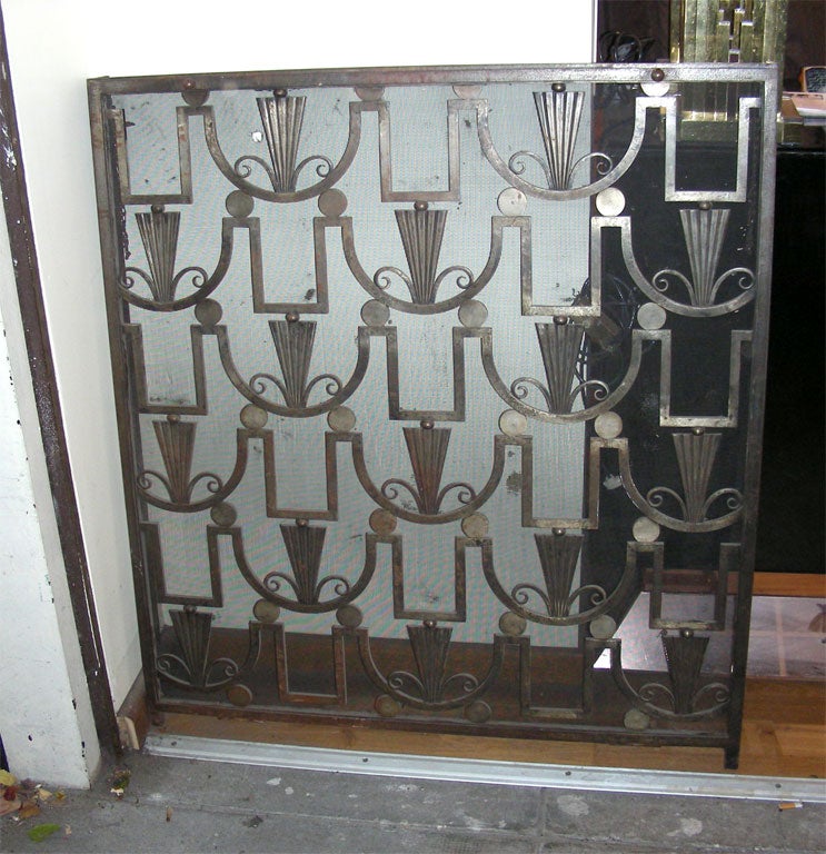 Handsome wrought iron gate from 1925 stamped by Edgar Brandt. Used to hide a radiator. Original patina, not cleaned.