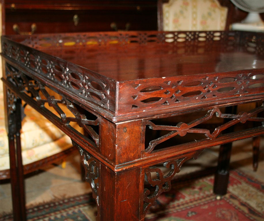 George III mahogany silver table with pierced gallery and apron on cluster column supports.