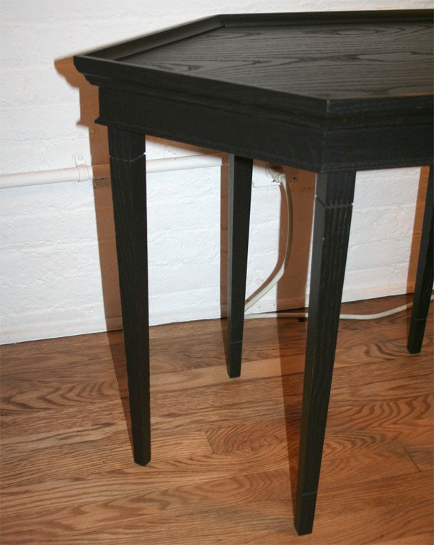 Ebonized wood occasional table with rimmed top and apron and tapered legs.  Shown in standard ebonized mahogany finish.  Others finish options available.