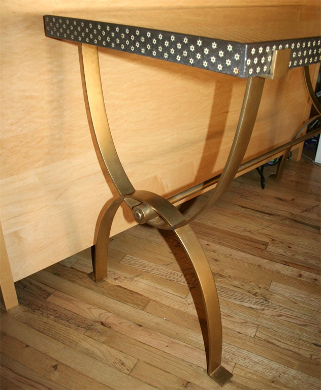 Unique console table with hand placed star printed resin top and U-shaped gold toned base connected by a 