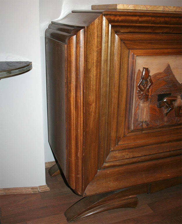 A walnut and marble buffet from circa 1930s, beautifully carved in relief with a colonial African scene. A Dominique design.
