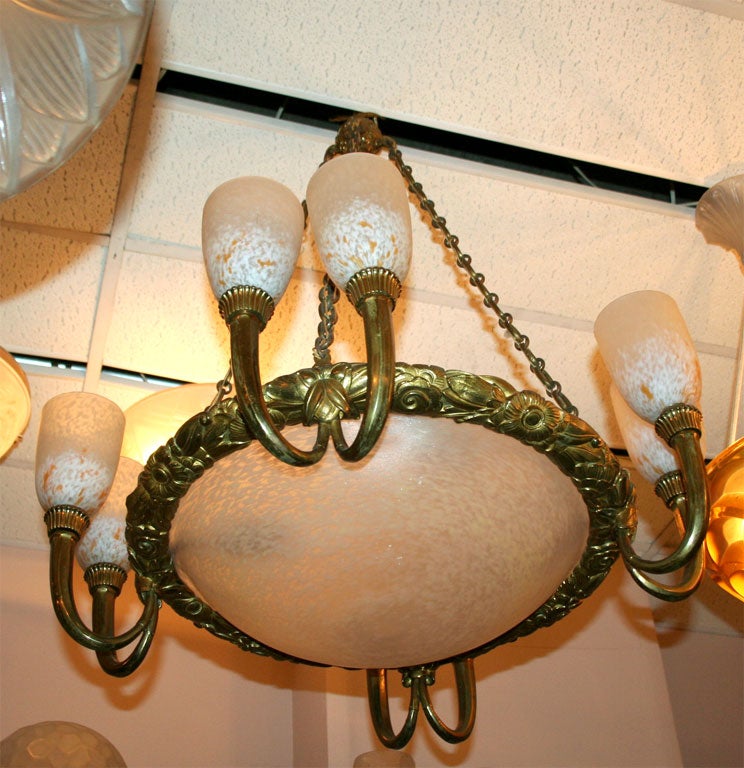 A French Art Deco chandelier by Schneider in

gilded bronze and motteled glass from circa 1925.