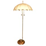 Single brass umbrella form floor lamp with vellum shade