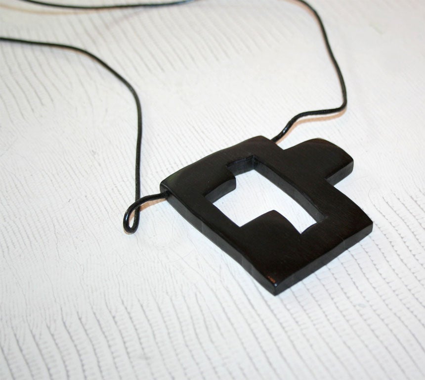 Cross pendant in ebony with leather cord.  With certificate of authenticity from Odile Noll.