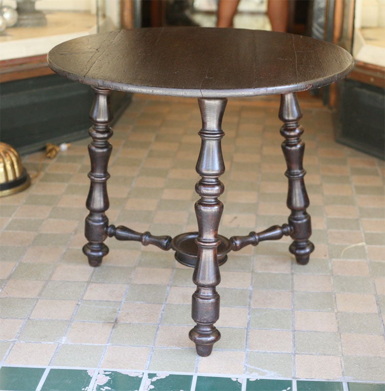 A beautiful tavern table with boldly turned legs and stretcher. The top is pine and the legs walnut.Originally the top would have been covered in oil cloth or leather for conveniate cleaning. The underside showing the tack marks from the