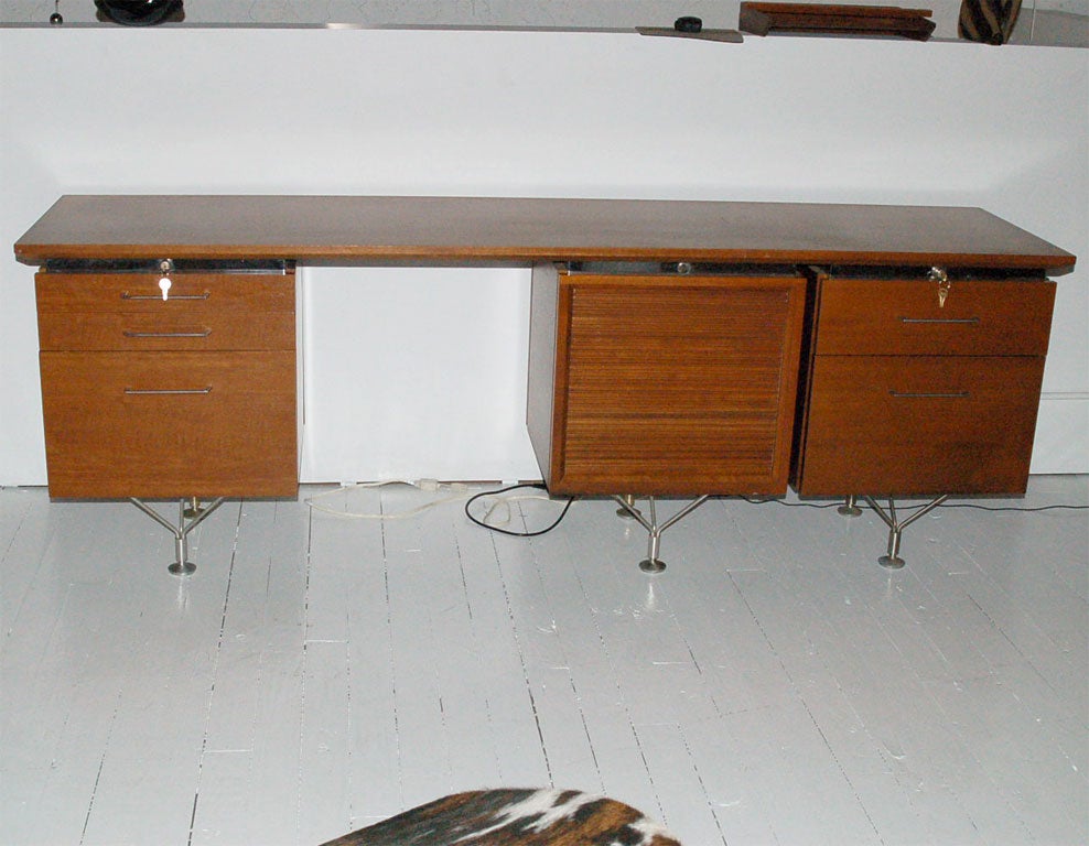 Desk by Stow Davis.  Left side has 2 drawers and a file drawer.  The middle has an adjustable shelf concealed by a sliding door.  The right side has one drawer and a file drawer.  ***Contact/Shipping Information: AOL (American Online) users may