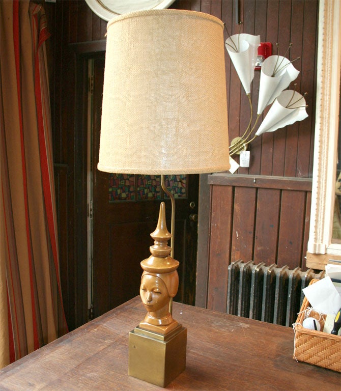 Asian head with pagoda-like headdress on a square brass base with original burlap lampshade.