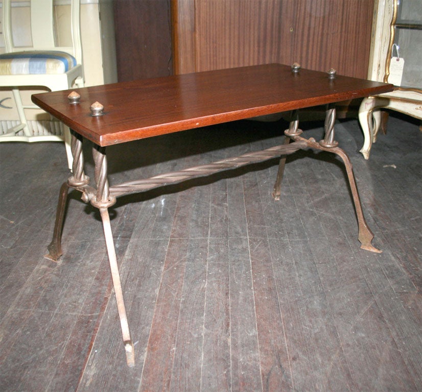 Handcrafted wood top table with handwrought iron frame.