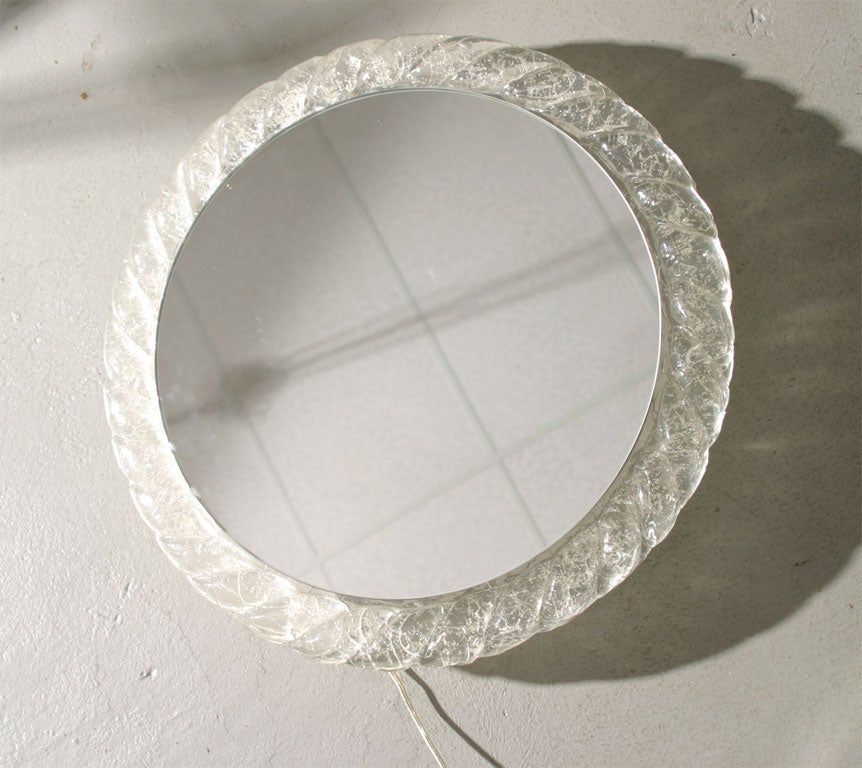 Circular lucite mirror from Italy which lights from behind. Please note the mirror has a 2 inch depth from the wall when mounted-- this gives the illusion of floating.