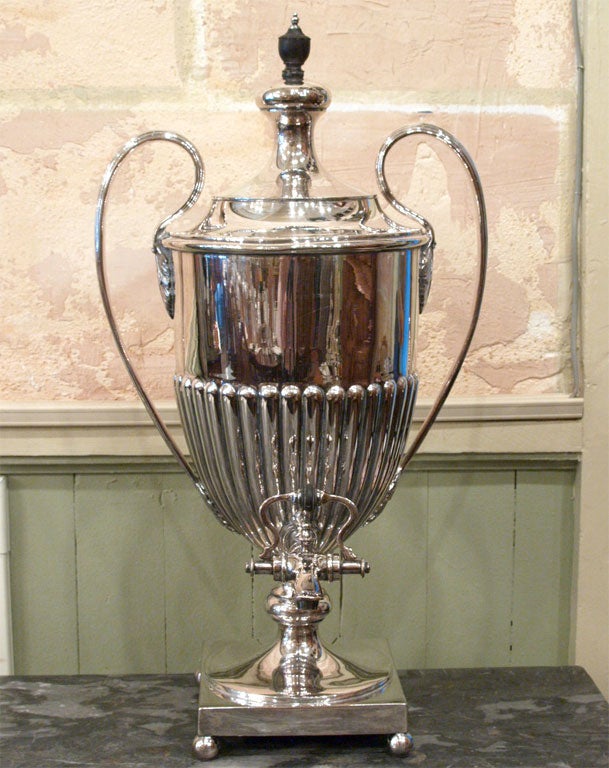 Large scale early 19th century English Regency style Old Sheffield rolled plate silver coffee urn in the Adams taste, with foliate decoration at handles and ebony urn finial, circa 1810, with later applied retailer's button of Walker and Hall,