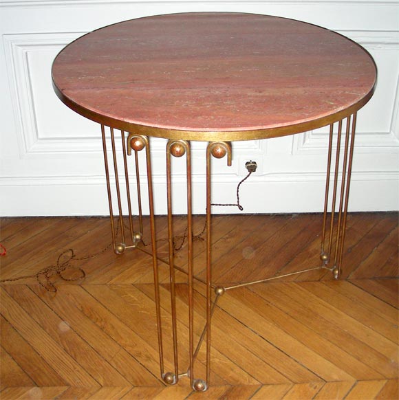 1940s gueridon by Jean Royère with a wrought iron base and a pink slate top surface. 