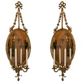 A pair of Louis XVI style girandole mirrors