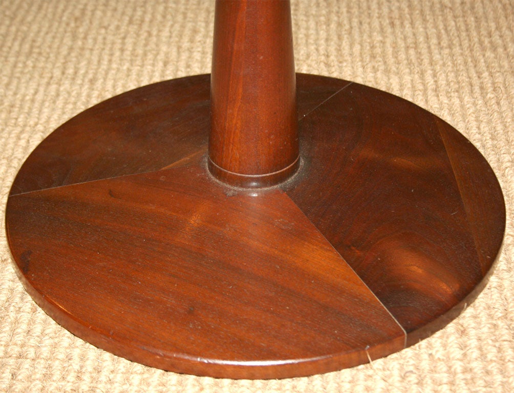 A pedestal base walnut occasional tables with pie section veneer top by Drexel, American, circa 1950.