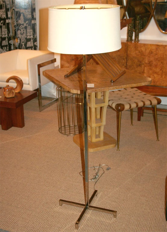 A quintessentially Modernist pair of nickel plated floor lamps with cross form bases and integral column mounted three way rotating collar switches by Hansen, NYC. U.S.A., circa 1950.