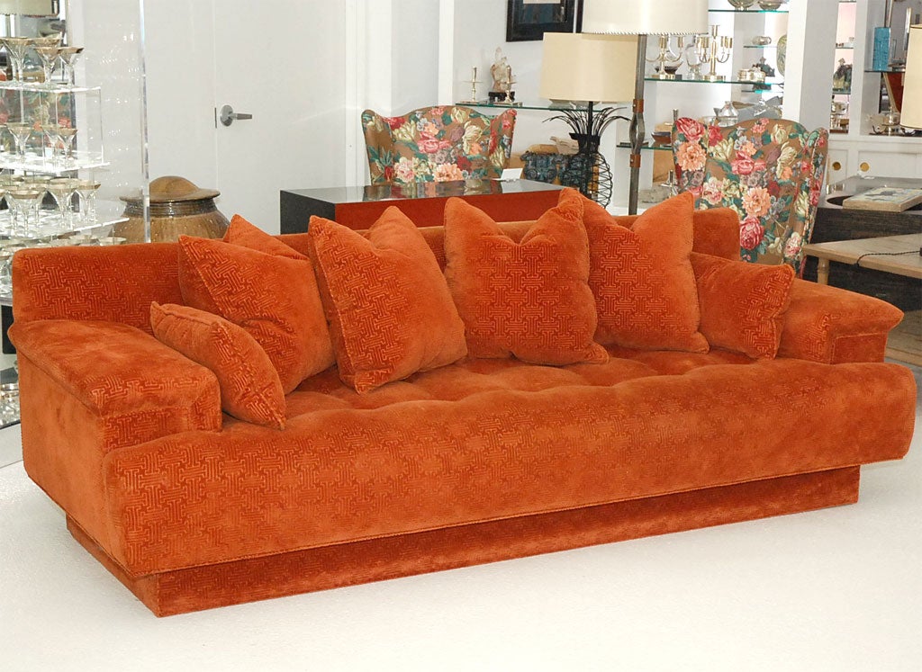 Large scale button-tufted sofa reminiscent of the 1970's with deep seating and overstuffed pillows.  The sofa is upholstered in the original burnt orange David Hicks-style patterned velvet.<br />
<br />
The length is 98