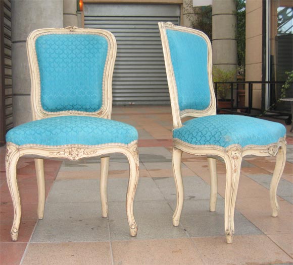 Two Louis XV style chairs in cream-colored patina and blue upholstery.