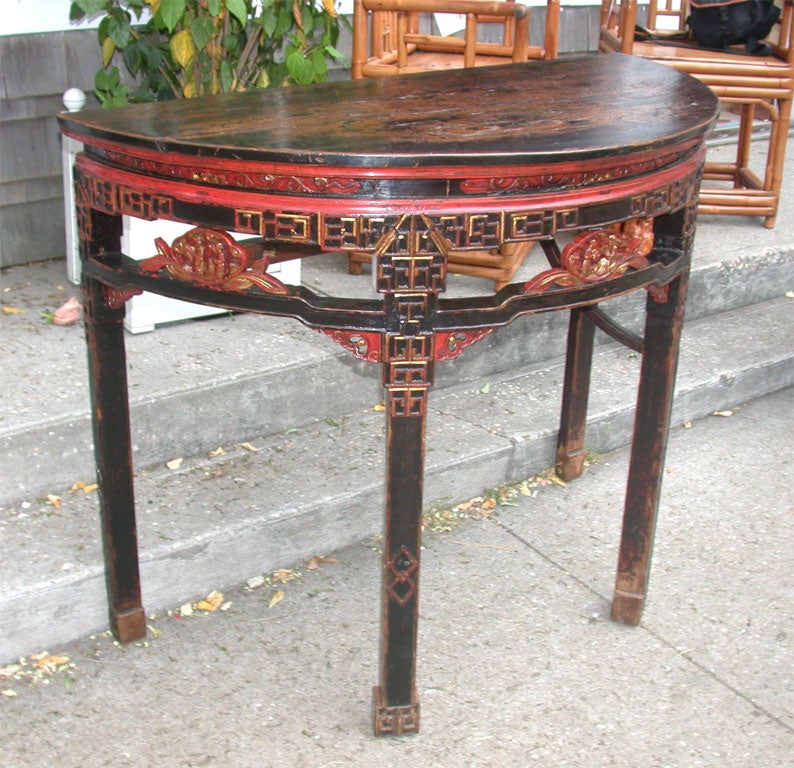 Late 19th century Q'ing Dynasty golden painted Jiangsu carved and decorated demilune tables (one available.)