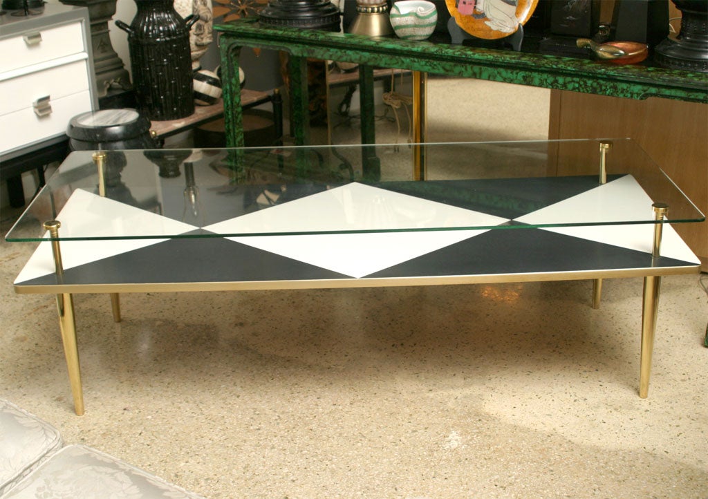 It's a Harlequin ROMANCE! Bold, in-your-face, 50's two-tiered coffee table has a glass top with a black and white Harlequin-patterned laminate shelf underneath. Gleaming brass legs and supports give this table a sexy Italian flair. Bellissima!