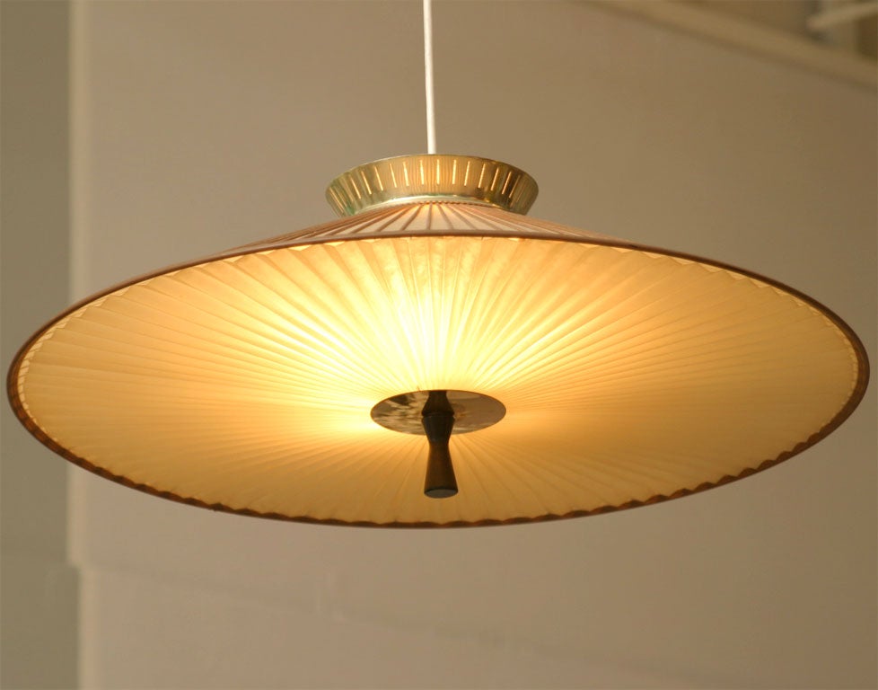Brass fittings and a fiberglas shade with walnut strips combine to create an Asian-inspired, mid-century classic by Gerald Thurston for Lightolier. 3-way lighting; 40w bulbs recommended.