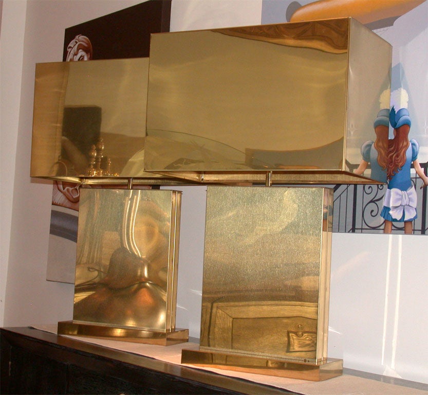 Monumental pair of brass lamps with accompanying brass shades signed and dated JERE.