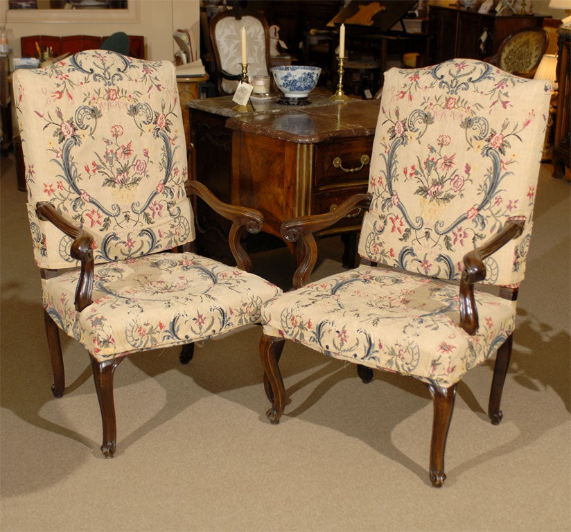 A pair of Italian Rococo period fauteuils, with needle-point linen slip covers, serpentine back and scroll arms ending in cabriole legs.

 