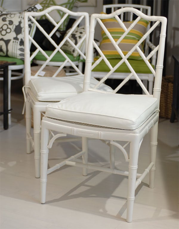 These vintage chairs have been updated with white semi gloss paint.  Faux bamboo frame with cane seats.  New custom made box seat cushion in white.  Self welt, zipper back and pencil thin ties.