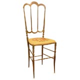 Brass chiavari chair with needle point seat.