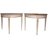 PAIR OF PAINTED AND PARCEL GILT DEMI-LUNE TABLES