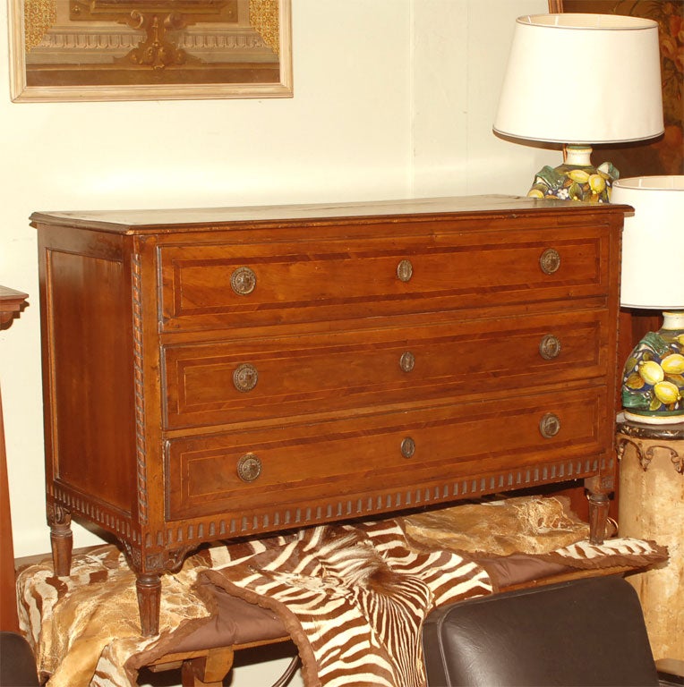 Elegant hand-carved three-drawer walnut commode with inlaid detail. 
Beautiful original finish and with original hardware.
Italy, 18th century.
Please note there is a small 2 inch square cut out of the back, otherwise in remarkable antique condition.