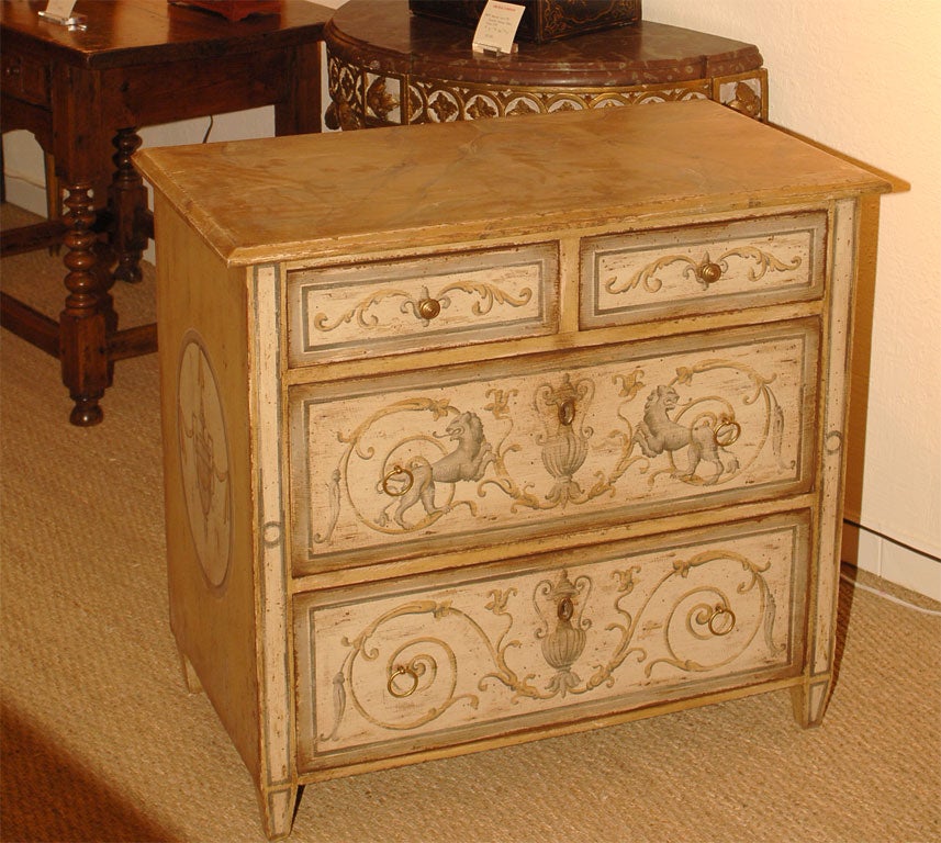 A Painted and Decorated Small Commode.  Two Short Drawers over 2 Long Drawers.<br />
In Creams and Light Ochre Colors.