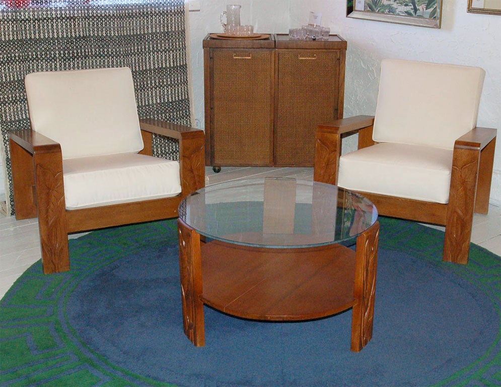 Fine & rare Hawaiian living room suite with 2 lounge chairs, cocktail table, and a pair of side tables.  Hand carved anthurium relief to the pair of chairs and coffee table.  Priced as a set.  Dimensions: chairs; 30