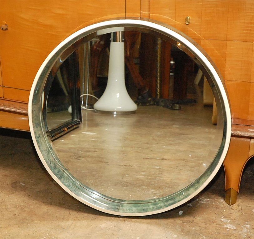 ROUND GREEN MIRROR WITH BONE AND PARCHMENT FRAME.