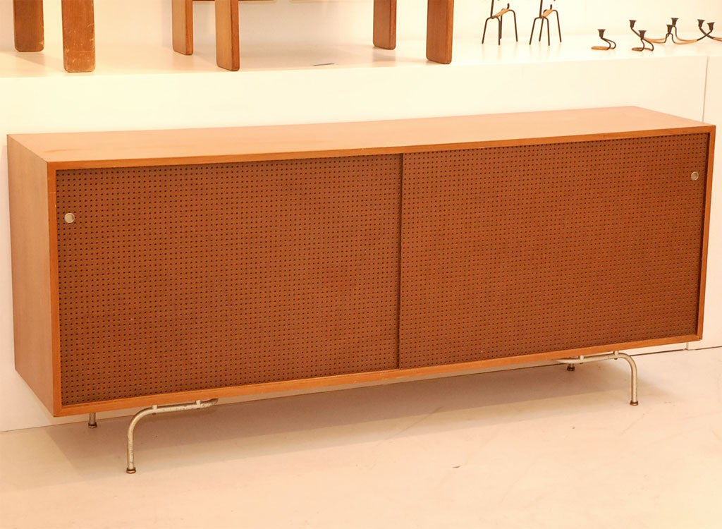 Rare Storage Credenza with same legs as early chair.  Pegboard Sliding Doors.  Untouched original condition.
