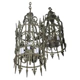 Pair of patinated wrought iron and brass lanterns