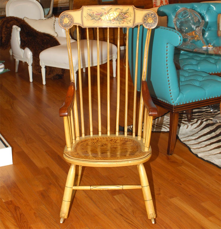 A true folk art piece with inset leather seat, spindle back and arms, and farmhouse yellow painted finish.