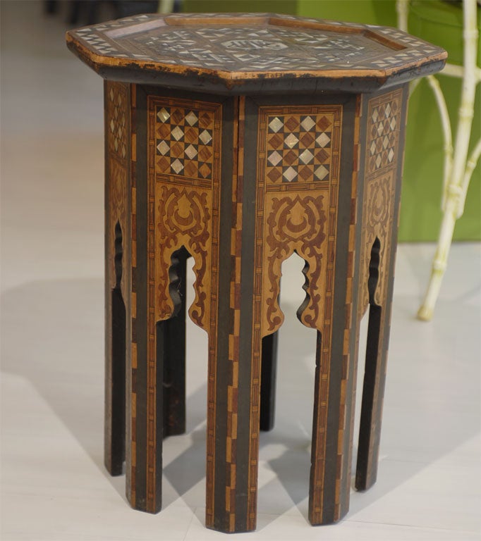 This vintage end table has a beautiful detailed inlay top and side panels.  Colorations of brown, gold, ivory and black.
