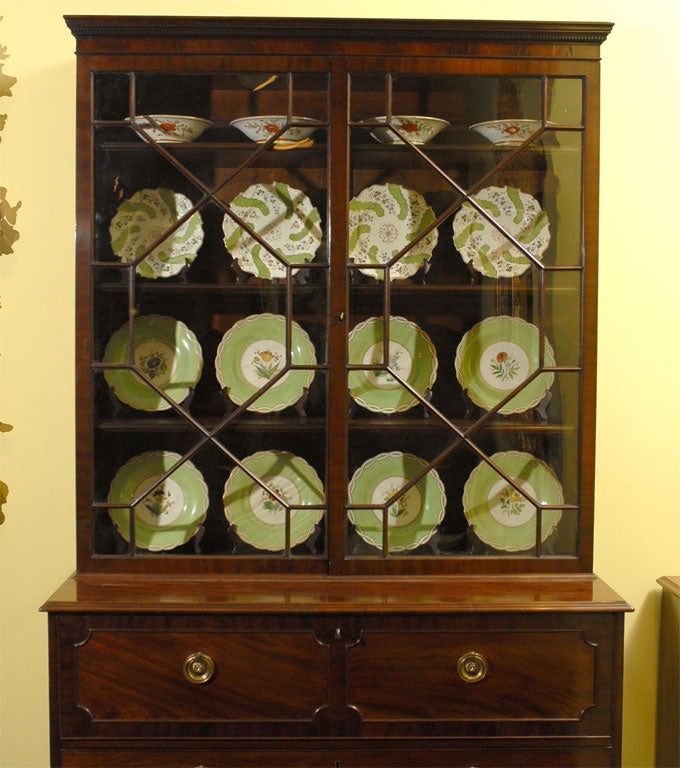 An 18th century mahogany secretary bookcase with a secretary drawer and three additional drawers on bracket feet