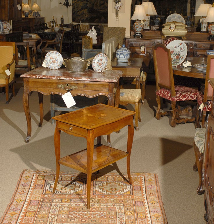 A graceful Louis XV period side table with a single sliding drawer. French in origin, dating from the mid 1700's. <br />
<br />
The frame in fruitwood composed of two tiers and a single sliding drawer, inlaid with various woods, the top featuring