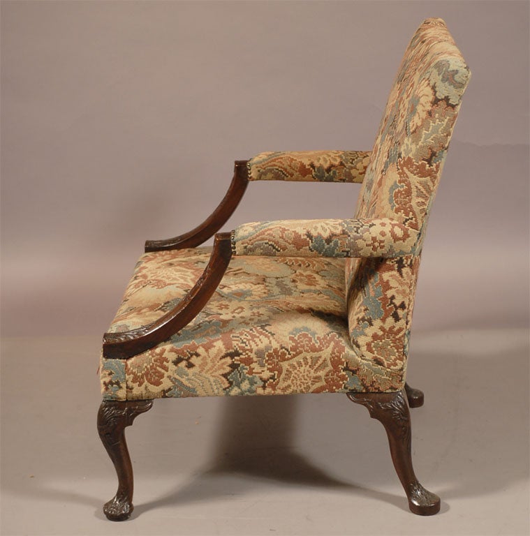 A fine George III period Library, or Gainsborough, armchair. The frame constructed in Mahogany and with later needle-point upholstery.<br />
<br />
The Mahogany frame rests atop four balanced cabriole legs, each with acanthus designs on the knee,