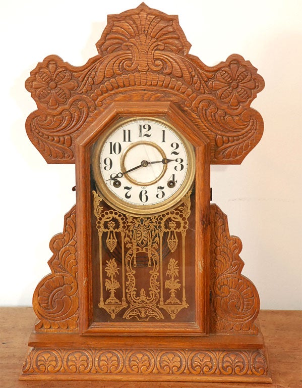 19TH C. GINGERBREAD MANTEL OAK CLOCK MADE BY WATERBURY CLOCK CO. IN WATERBURY CONNECTICUT.  VICTORIAN STYLE WITH ORIGINAL FACE AND GLASS WITH KEYWIND & ORIGINAL KEY.  CLOCK IS IN WORKING ORDER