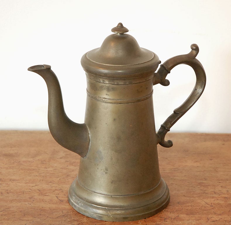 RARE AMERICAN PEWTER PITCHER WATTACHED LID  THE TOP OF LID  HAS VARIOUSBHALLMARKS THIS PITCHER WONDERFUL  CURVED HANDLE THE CONDITION IS VERY GOOD AND HAS A NICE PATINA