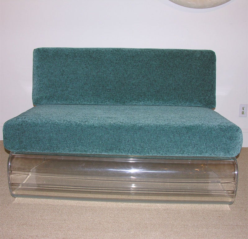 The L shaped folded lucite formed bench, with deep upholstered cushions for the seat and back.