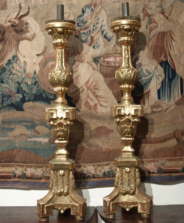 Large pair of Louis XVI style altar candlesticks of large-scale. These are exceptional size and gilt, they came from a monastery outside of Lucca, Italy.
They have the original tin cups and have a great foliate decoration.
They are one sided so