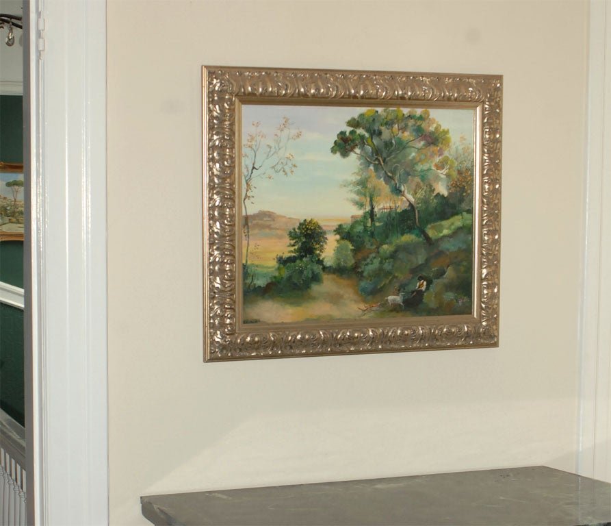 A lush green landscape oil on canvas in an ornate silver leaf frame with signature 