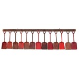 Vintage Sandshovels Suspended from Wooden Rack with Iron Hasps