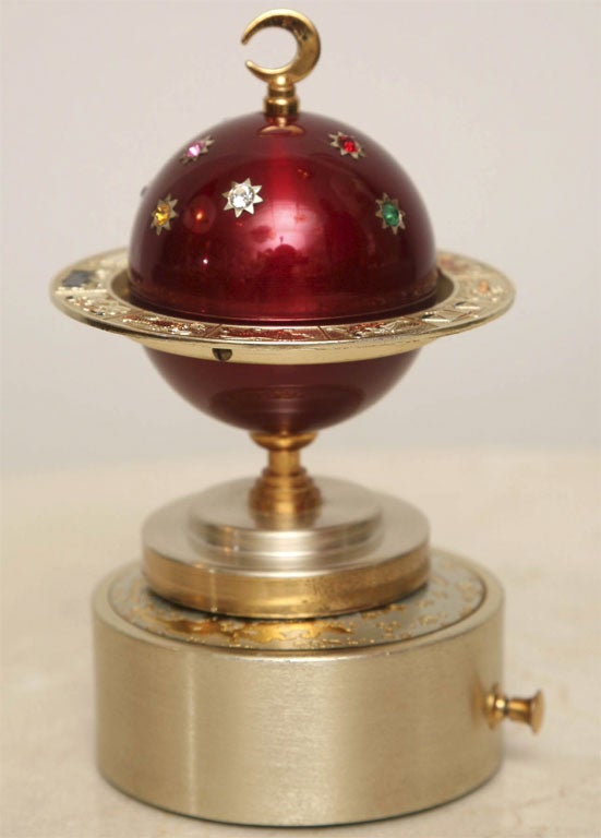 Not another Faberge Egg for the Holidays! Decidedly quirky, admittedly chic, anodized aluminum and vermeil 60's lighter features a multi-colored constellation of faux gemstones on a ruby-red enamelled sphere - all encircled by faux-enamel zodiac
