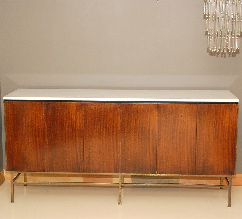 Great mahogany/brass McCobb Irwin Collection Server. White Carrera marble top. Tri-fold doors open to adjustable shelf and four drawers.